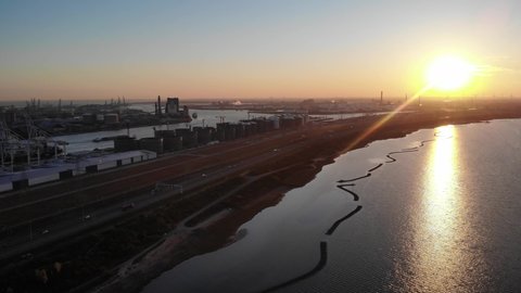 Beautiful Yellow Sunset Reflection On Calm Waters In Brielse Meer At Maasvlakte Port Of Rotterdam In Netherlands. - Aerial Shot