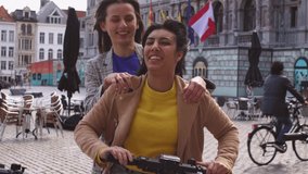 two multiracial girls have fun and play together on electric scooter - Powered by Shutterstock - Get 15% off with code: PIKWIZARD15