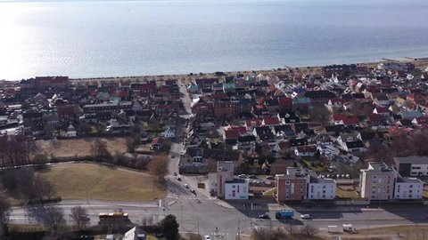 Aerial footage over sunny Helsingborg in Skåne, Sweden. Drone flying close to coast side in picturesque city.