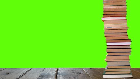 A pile of books growing on a green background.