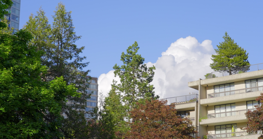 Establishing shot of modern apartment building with beautiful landscape in Vancouver, Canada, North America. Day time on May 2021. Still camera view. ProRes 422 HQ., a Business & Finance Video by karamysh