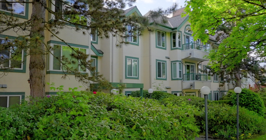 Establishing shot of modern apartment building with beautiful landscape in Vancouver, Canada, North America. Day time on May 2021. Still camera view. ProRes 422 HQ.
