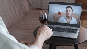 Family party online. A view of a family party on distance with a glass with wine in quarantine.