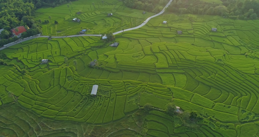 Aerial view of view sunset at Terraced Rice Field in Ban Pa Pong Piang , Mae Chaem District, Chiang Mai Province , Thailand. 4k drone footage Terraced Rice Field at sunset with clouds rain Royalty-Free Stock Footage #1073162885