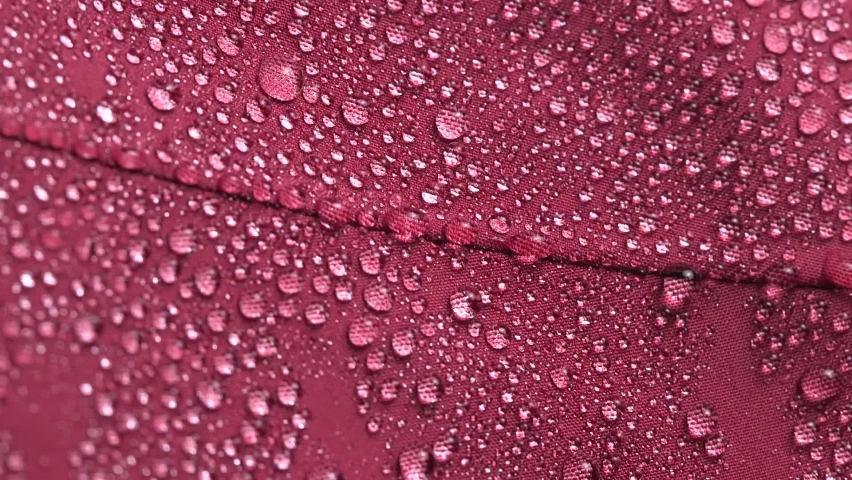 Slow motion close-up of falling water drops on waterproof membrane Gore-Tex cloth. Royalty-Free Stock Footage #1073163929