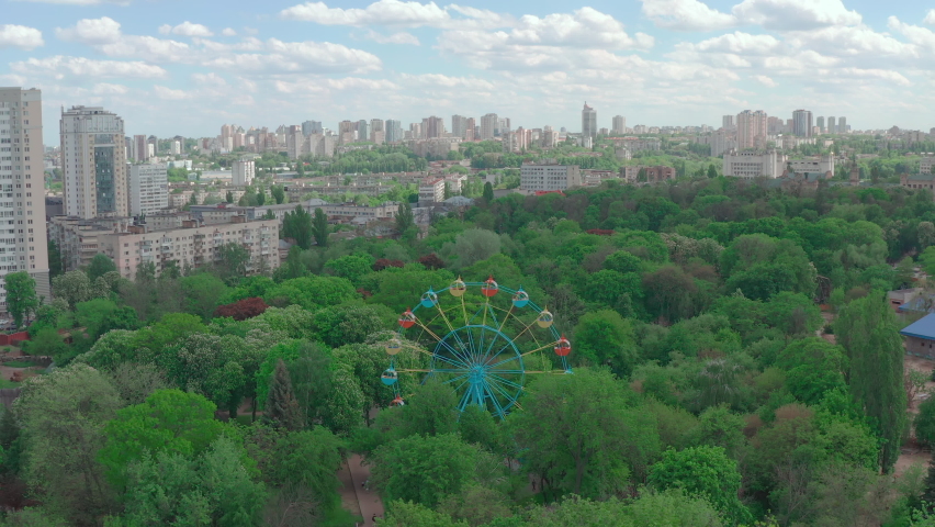 Ferris wheel in the city park. amusement park in the Kiev zoo. beautiful ferris wheel in the green area of the city park. 4k 