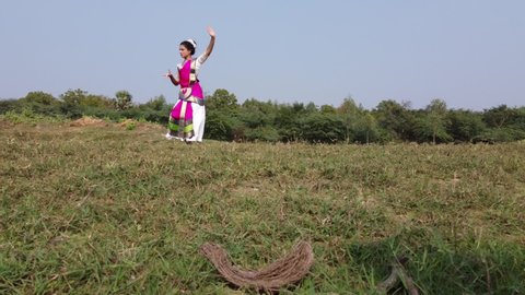 A bharatnatyam dancer displaying a classical bharatnatyam pose in the nature of Vadatalav lake, Pavagadh. Beautiful indian girl dancer in the posture of Indian classical dance bharatanatyam .