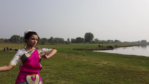 A bharatnatyam dancer displaying a classical bharatnatyam pose in the nature of Vadatalav lake, Pavagadh. 