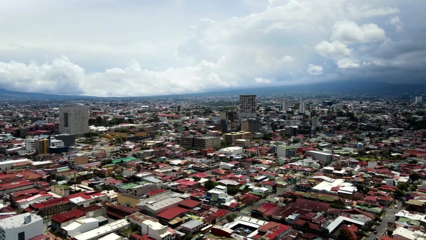 Beautiful cinematic aerial view of the City of San Jose Costa Rica, its buildings, Sabana Park and National Stadium