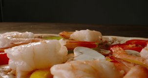 Close up shot pizza with mozzarella cheese, tomato sauce, apepper and shrimp. mediterranean cuisine, food and drink 4k footage