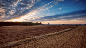 Sunset over plowed field at early winter, 4k time lapse.