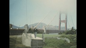 Archival seventies footage, point of view of vintage car crossing Golden Gate Bridge from Presidio Pacific point to the north. 1970s Archival of California, United States of America in 1976.