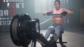 Asian fitness woman with perfect body in sportswear that showing six-pack abs, doing a cardio workout by sitting pushing legs straight while pulling the handle to her chest on a rowing machine in gym. - Powered by Shutterstock - Get 15% off with code: PIKWIZARD15