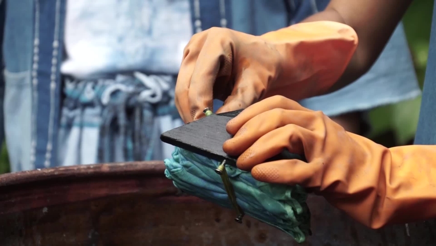 Handmade traditional technique of fabric dyeing in natural indigo colour in Thailand