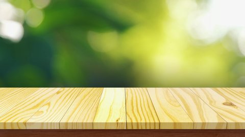 Empty wooden table top with abstract natural blur bokeh background for used display products