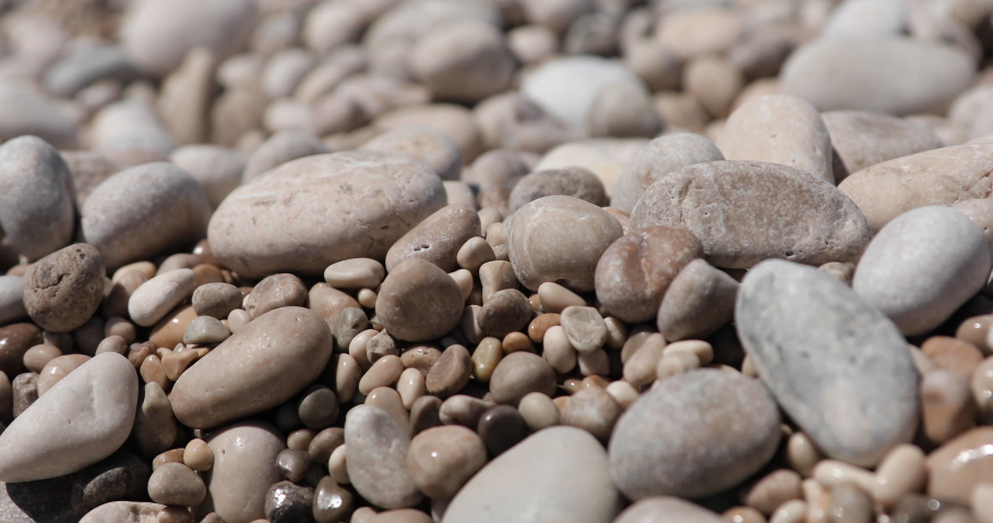 Beach texture with pebbles thrown on shore, travel and vacation concept