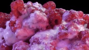 Close-up of fresh raspberries poured cream, yogurt. Spinning video.