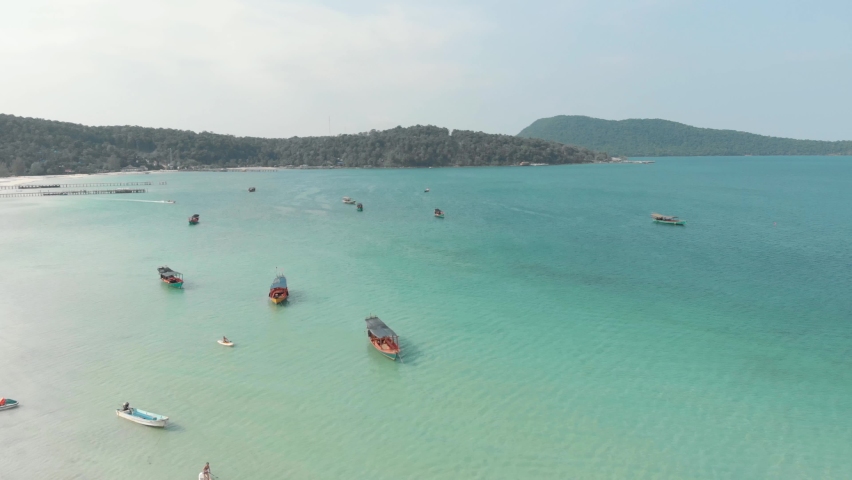 Cambodian wooden rural fishing boats resting on the turquoise exotic Saracen Bay in Koh Rong Sanloem, Cambodia - Aerial Panoramic shot | Shutterstock HD Video #1073206766