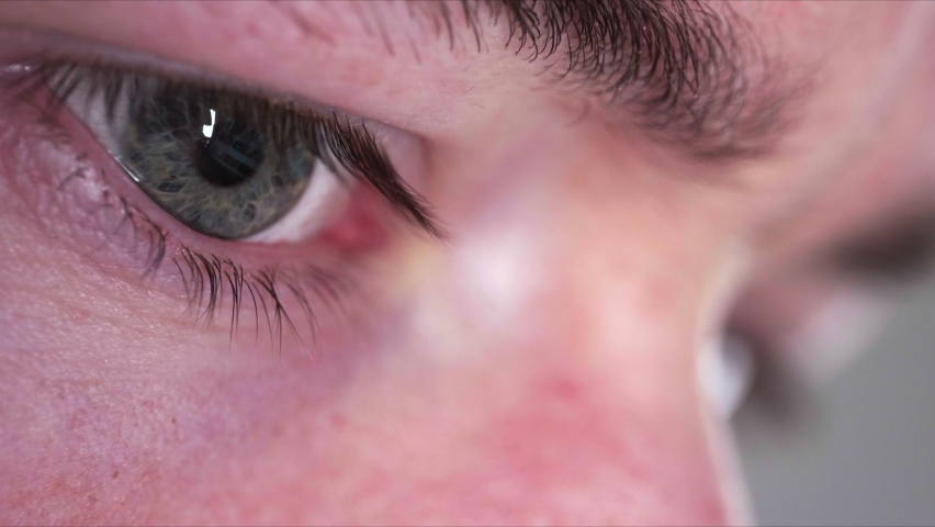 Macro Shot Of Human Eyes Browsing Smartphone With Screen Reflected On Eye