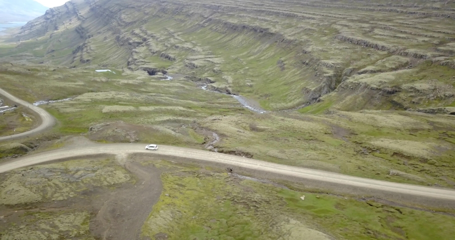 Car driving in Iceland mountain landscape road, Aerial view
drone view over white private car driving along dirt road in east Iceland, February 2021
