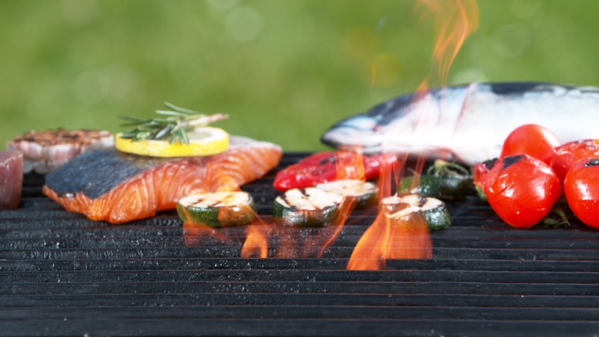 Super slow motion of falling shrimps and octopus tentacle on grill grid. Filmed on high speed camera, 1000 fps