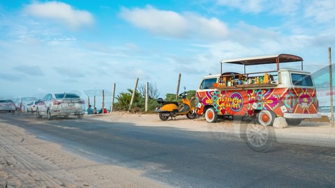 Tulum beach, Mexico. May 25, 2021. Hippie Volkswagen kombi Vintage car on the beach redesigned as a bar serving tequila. Timelapse view.