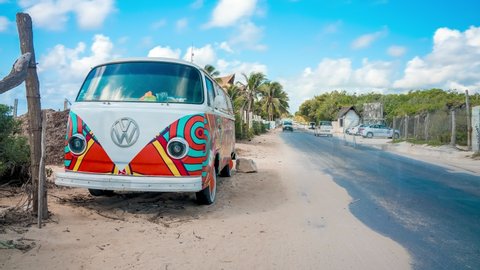 Tulum beach, Mexico. May 25, 2021. Hippie Volkswagen kombi Vintage car on the beach redesigned as a bar serving tequila. Timelapse view.