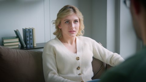 Young active girl talking about herself in psychological therapy in the therapist's office. Professional conducts psychotherapy for a young woman