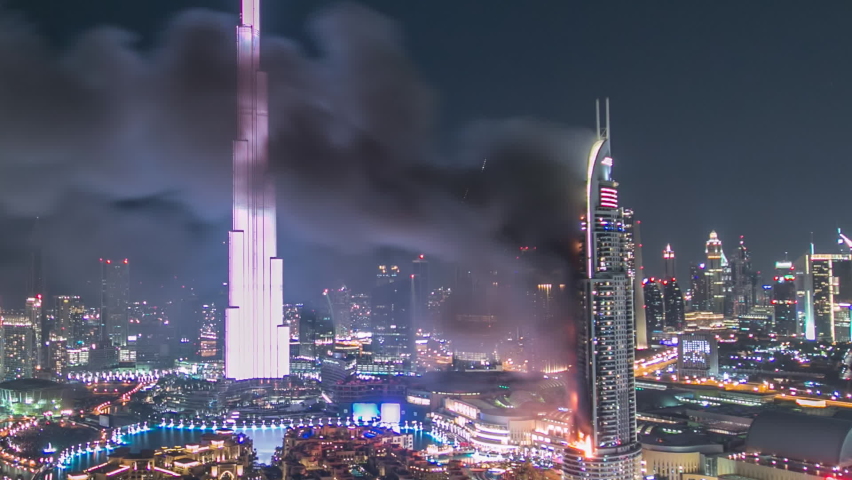 DUBAI, UAE - 1 JAN 2016: Huge Fire accident occured from the The Address Hotel and Dubai Burj Khalifa before New Year 2016 fireworks celebration timelapse on January 1,2016 at Dubai, UAE. View from