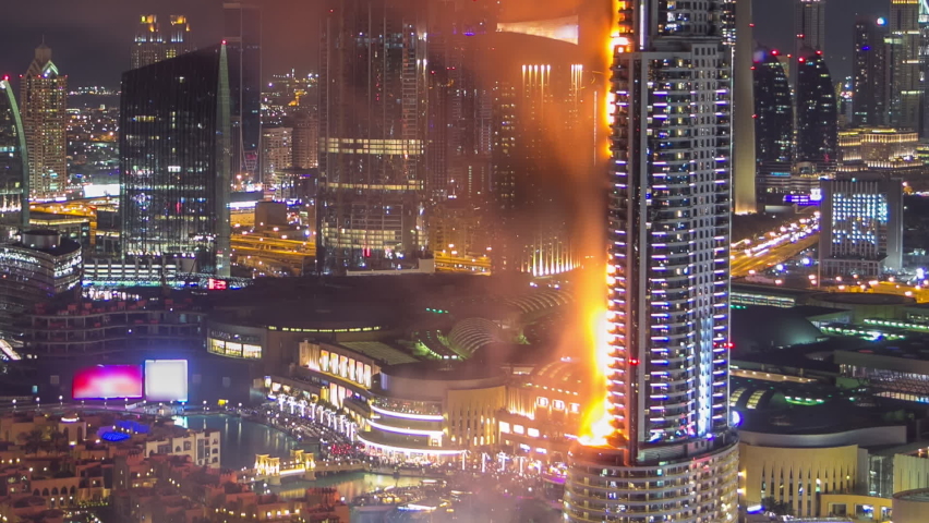 DUBAI, UAE - 1 JAN 2016: Huge Fire accident occured from the The Address Hotel near Dubai Burj Khalifa before New Year 2016 fireworks celebration timelapse on January 1,2016 at Dubai, UAE. View from