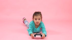 Sweet pretty preschool girl staying home playing video games with excitement. Winning cheering up enjoying leisure. Home technology. Children. Kids.
