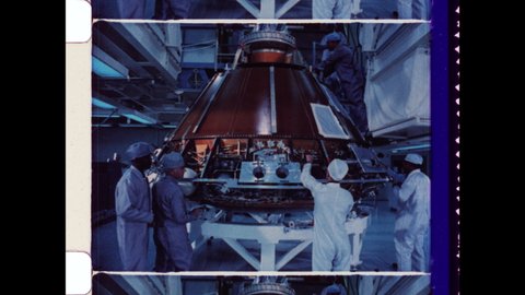 1969 Cape Canaveral, FL. NASA Engineers, Scientist, and Technicians work on Command Module Columbia, tracking Backwards to Reveal size of the Orbital Module. 4K Overscan of Archival 16mm Film