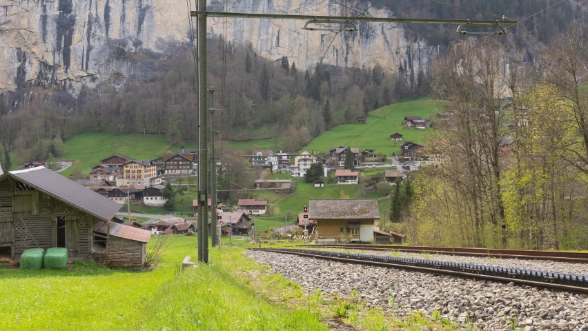 Timelapse cars and trains traffic in small Swiss Alpine town. Lauterbrunnen. Lauterbrunnen Valley, Berner Oberland, Switzerland.