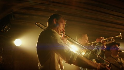 HANHDHELD CU Portrait of jazz band members playing brass instruments on stage during a live concert in small venue. Shot on ARRI Alexa Mini with 2x anamorphic lens