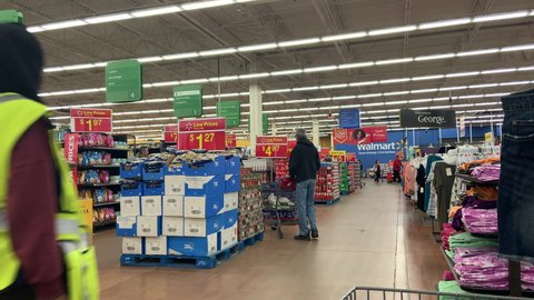 Hamilton, Ontario, Canada - May 2020: Shoppers and workers are busy walking the aisles at the Walmart store.