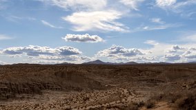 Clouds casting shadows on Red Rock Canyon roll across the sky above the Mojave Desert landscape - static time lapse - Powered by Shutterstock - Get 15% off with code: PIKWIZARD15