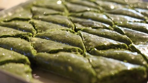 Close-up video of Gaziantep's famous green baklava standing in the restaurant on the tray