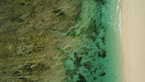 Top down view on sandy Pandawa beach with reef in Bali Indonesia. High quality 4k aerial birds view footage