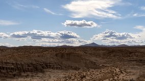 Panoramic time lapse of Red Rock Canyon in the Mojave Desert on a hot summer day with billowing clouds above the rugged terrain - Powered by Shutterstock - Get 15% off with code: PIKWIZARD15