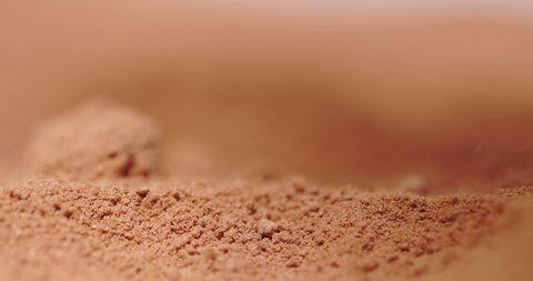 Powder flowing as sand like object closeup