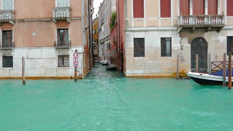 Venezia, Italy - 02 02 2018: Tracking shot taken from a ferry in Venice. Venetian palaces in a cold rainy day.