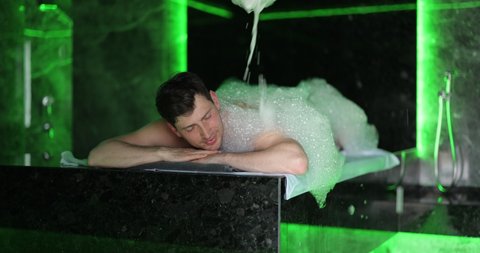 Man on the procedure of the foam massage in the hammam. Wellness and spa concept