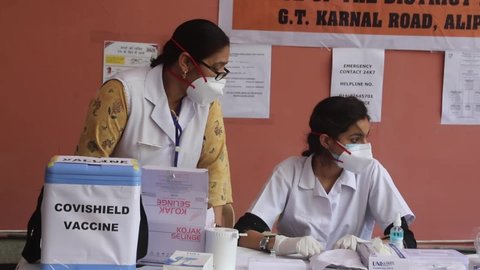 New Delhi, India, May 29, 2021: A healthcare worker administers a dose of Covid-19 vaccine against the coronavirus infection to the beneficiary at a drive-through Covid-19 vaccination campaign. 