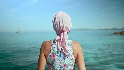 Woman with a pink head scarf has cancer