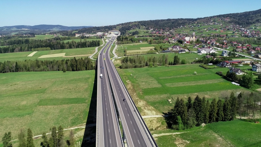 New highway in Poland on national road no 7, E77, called Zakopianka.  Skomielna  Biała village and the old road on the right. Far view of a tunnel under construction