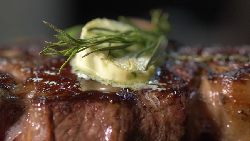 Close-up of the chef in the restaurant's kitchen serving a signature meat dish