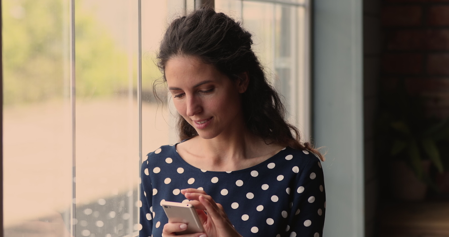 Head shot pretty millennial hispanic woman looking at cellphone screen, reading message with unbelievable good news, celebrating online lottery gambling giveaway win, getting secret sale notification. Royalty-Free Stock Footage #1073311679