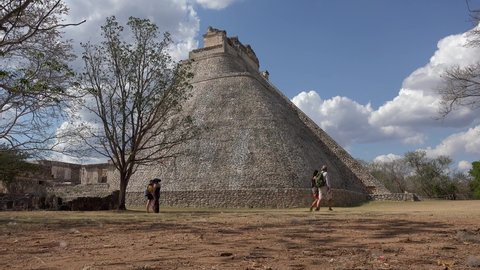 Uxmal, Yucatan, Mexico - APRIL 02, 2019:
Tourists at the Pyramid of the Magician.
