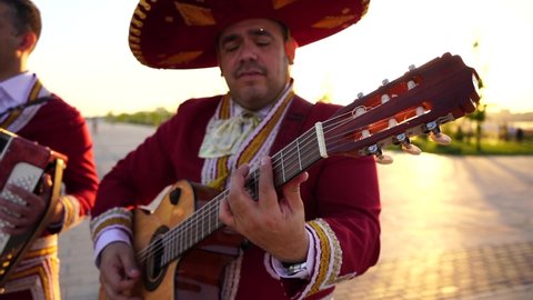 Mexican musicians mariachi band street concert. Slow motion
