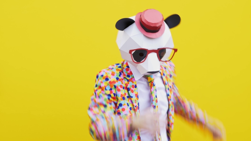 Funny character with mask dancing and having fun on a colored background Royalty-Free Stock Footage #1073325569